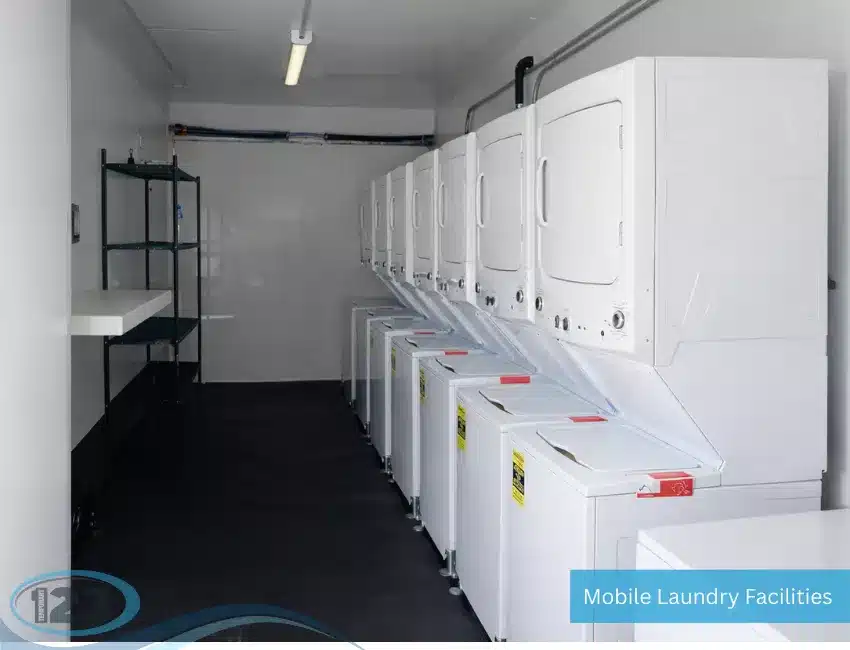 Clean, well-lit interior of a mobile laundry trailer featuring stacked laundry machines.